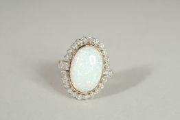 A 9CT GOLD OPAL AND DIAMOND OVAL RING.