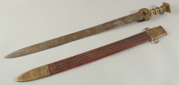 A GERMAN SWORD in a leather scabbard with brass handle. 34ins long.