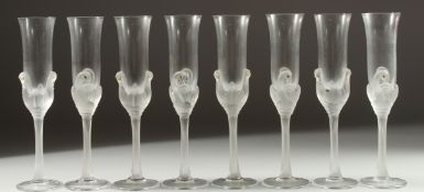 A GOOD CASED SET OF EIGHT JEAN-CLAUDE SWAN CHAMPAGNE GLASSES each 10ins long.