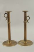 A PAIR OF EARLY TALL BRASS CANDLESTICKS. 12ins high.