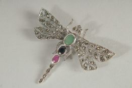 A SILVER, EMERALD, RUBY AND SAPPHIRE MARCASITE DRAGON FLY BROOCH.