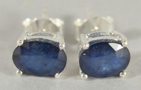 A PAIR OF SILVER AND REAL SAPPHIRE STUD EARRINGS.
