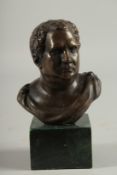 A BRONZE BUST HEAD OF A ROMAN. 4ins high on a marble base.