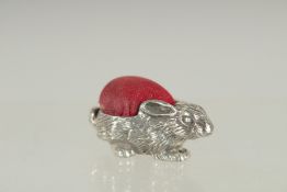 A NOVELTY SILVER RABBIT PIN CUSHION. 1.25ins long.
