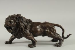 A BRONZE LION. 16ins long.