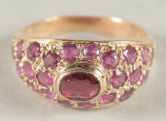 A 14CT GOLD RUBY GYPSY RING.