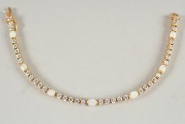 A SILVER GILT AND OPAL BRACELET.