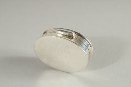 A SILVER GLAMOUR MODEL PILL BOX.