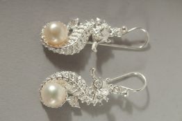A PAIR OF SILVER AND PEARL SEA HORSE EARRINGS.