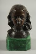 A BRONZE BUST HEAD OF A GIRL. Signed. 4ins high on a marble base.