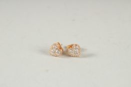 A PAIR OF 18CT GOLD DIAMOND HEART SHAPED STUD EARRINGS.