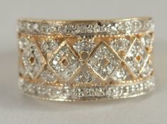 A 9CT GOLD DIAMOND SET WIDE RING.