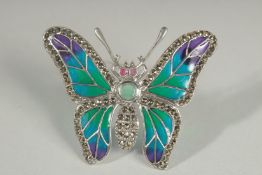 A SILVER PLIQUE A JOUR EMERALD BUTTERFLY BROOCH.