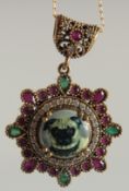 A SILVER RUBY AND EMERALD PUG DOG PENDANT AND CHAIN.