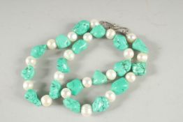 A ROW OF CULTURED PEARLS AND TURQUOISE BEADS 19ins long.