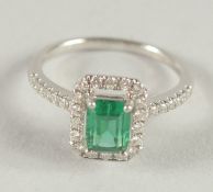 AN 18CT WHITE GOLD COLUMBIAN EMERALD AND DIAMOND RING.