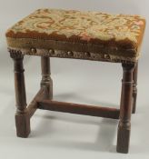 A GOOD 18TH CENTURY OAK STOOL with needlework top. 18ins high.