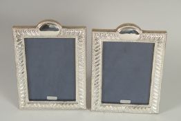 A PAIR OF SILVER PHOTOGRAPH FRAMES. 7.5ins x 5ins