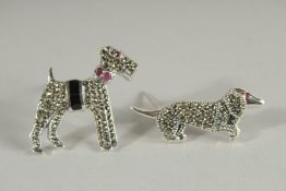 TWO SILVER DOG BROOCHES.