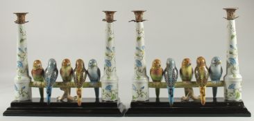 A GOOD PAIR OF PARAKEET COLUMN CANDLESTICKS with five birds on a pole. 14ins high.
