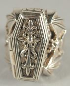 A SILVER COFFIN AND BAT SET RING.