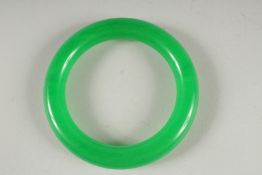 AN APPLE GREEN JADE BANGLE. 3.25ins diameter.
