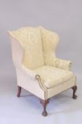 A GOOD MAHOGANY WING ARM CHAIR on cabriole legs ending in claw and ball feet.