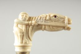 A WALKING STICK with carved bone handle. 