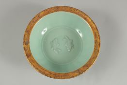 A CHINESE CELADON GILT RIM DISH, 24cm diameter.