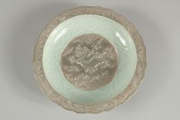 A CHINESE CELADON CARVED DRAGON SILVERED DISH, 19.5cm diameter.