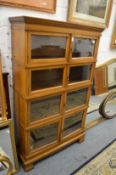 A Simpoles Chapter bookcase comprising four stacking sections, each with a pair of glazed doors.