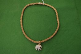 A decorative rope twist necklace with elephant pendant.