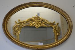 Decorative gilt framed oval wall mirror.