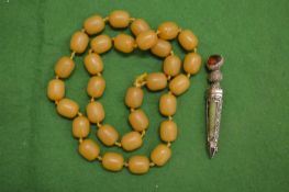 Bead necklace and a decorative brooch.