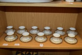 A set of eleven Cauldon china gilt decorated coffee cups and saucers.