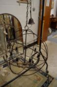 A large pair of wrought iron globe shaped chandeliers.