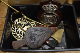 A brass plaque, bellows and other items.