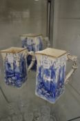 A graduated set of three blue and white jugs.