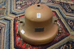 A large copper and brass spot light or lantern.