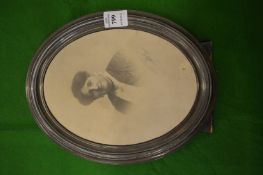 An oval silver photograph frame.