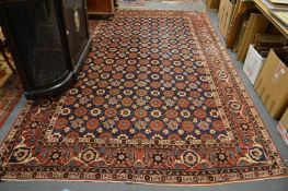A good Persian carpet, blue ground with all over flower head design, 345cm x 215cm.