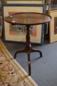A George III mahogany circular tilt-top tripod table.