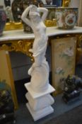 A painted reconstituted stone classical female figure on a pedestal base.