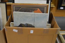 A box of paintings and prints.