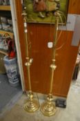 A pair of brass standard lamps.