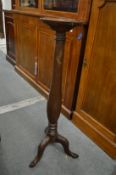 A mahogany torchere.