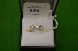 A good 18ct gold and diamond three stone ring, size P.
