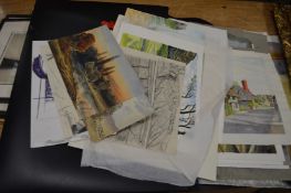 A folder of unframed artwork.