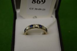 An 18ct white gold, diamond and sapphire seven stone ring, size N½.
