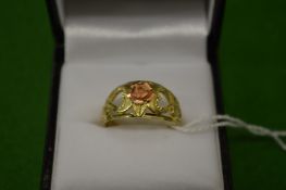 A decorative yellow and pink metal ring, pierced with hearts, stamped 10K, size N.